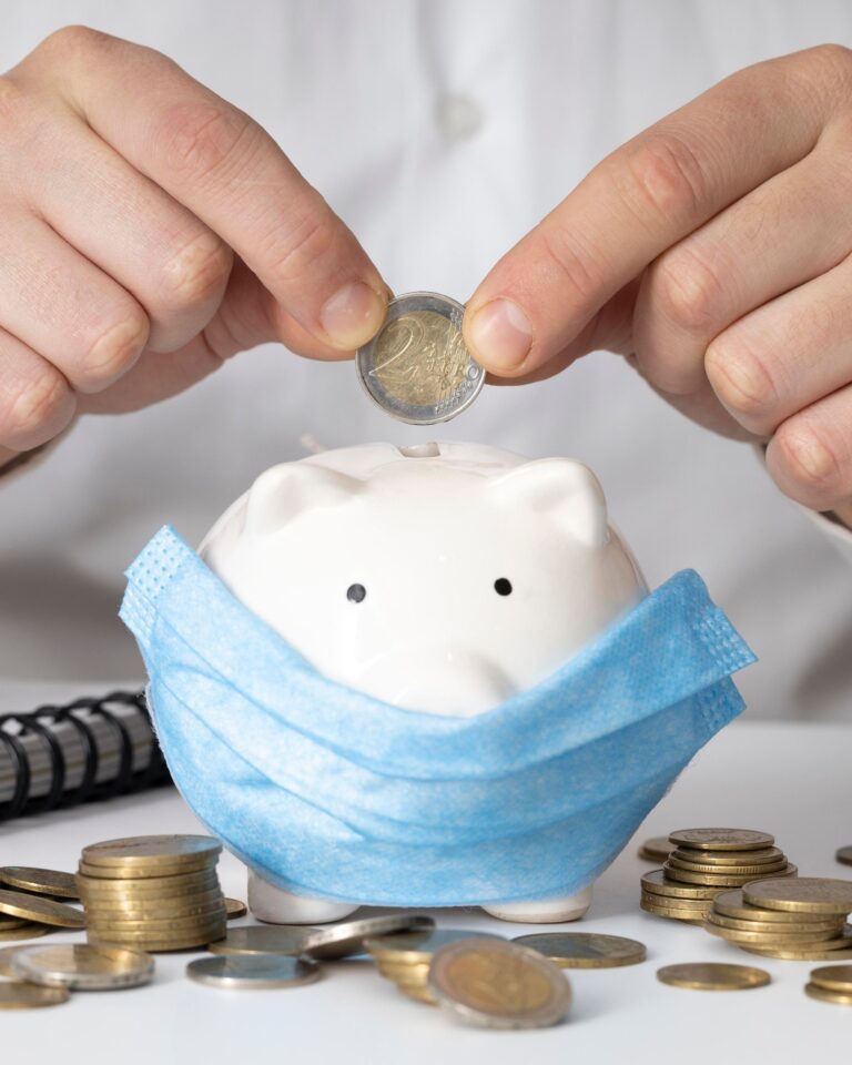 man-inserting-coin-piggy-bank-with-medical-mask