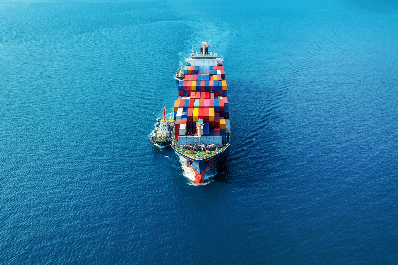 Aerial view of cargo ship with cargo container on sea.